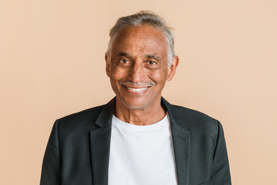 Happy mixed Indian senior man in a blazer
