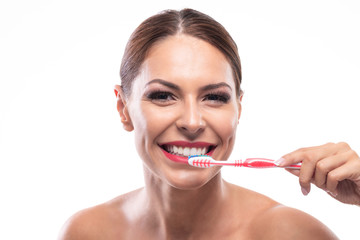 Woman with a beautiful smile preparing to brush her teeth