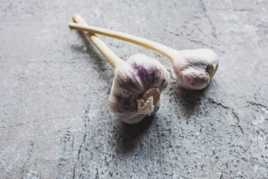 Whole Fresh Garlic On Grey Concrete Surface