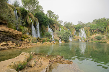 Obraz premium Kravica waterfall is a large tufa cascade on the Trebižat River, in the karstic heartland of Herzegovina in Bosnia and Herzegovina. is a popular swimming and picnic area.