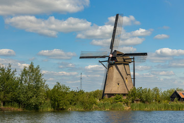 Old windmill on dutch landscape, Kinderdijk is a village in the municipality of Molenlanden, in the province of South Holland, Netherlands