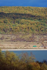 lake in fall season reflecting colorfully forest on the day