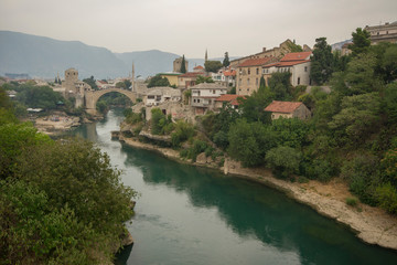 Fototapeta na wymiar Stari Most, also known as Mostar Bridge, is a rebuilt 16th-century Ottoman bridge in the city of Mostar in Bosnia and Herzegovina that crosses the river Neretva and connects the two parts of the city