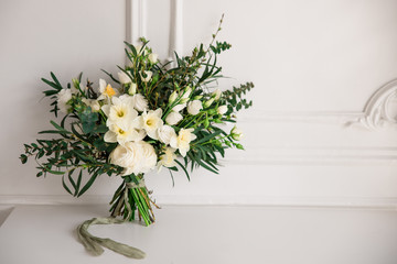 Modern large spring wedding bouquet with daffodils, ranunculus and various greens