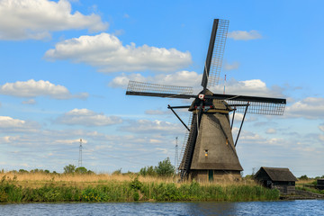 Old windmill on dutch landscape, Kinderdijk is a village in the municipality of Molenlanden, in the province of South Holland, Netherlands