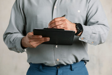 Engineer writing a report on a paper clipboard