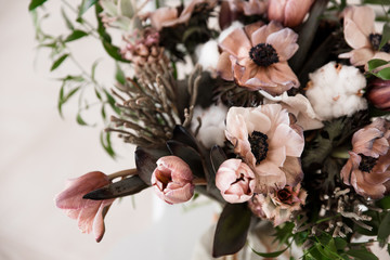 Modern unusual beautiful wedding bouquet of anemones, tulips and cotton
