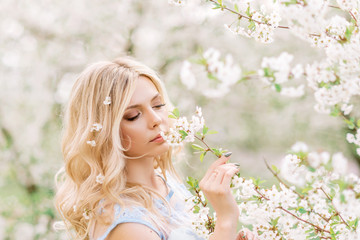 Fototapeta premium portrait of a woman in a blooming garden.