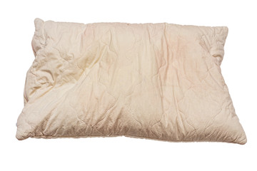 dirty used spotted crumpled nasty pillow isolated on white background in slanted frontal perspective