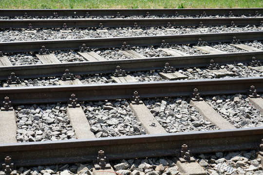 Hardened steel railroad tracks photographed on a sunny spring day