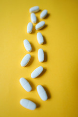 White pills  on a colorful background with a free area for text