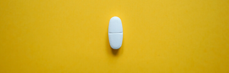 White pills  on a colorful background with a free area for text