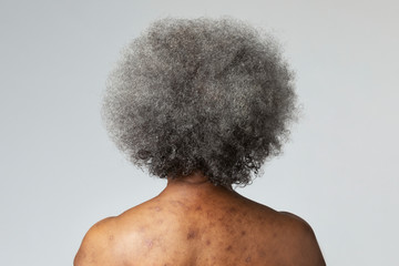 Back view of a senior African American woman - Powered by Adobe