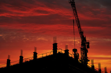Silhouette Construction worker of Building crane on construction site background.