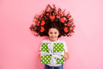 Top view above high angle flat lay flatlay lie concept portrait of her she nice cheerful wavy-haired girl many heart cards in hair holding in hands giftbox isolated on pink pastel color background