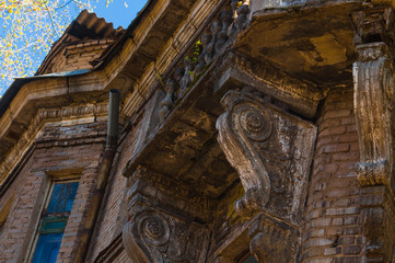 Elements of architectural decorations of buildings, a beam, a bracket under the balcony and a column, plaster patterns and stucco. On the streets, public places.