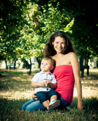 mom with son in her arms in the park