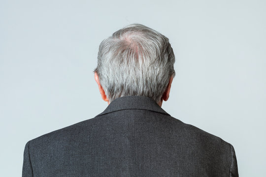 Rear view of a senior man in a suit