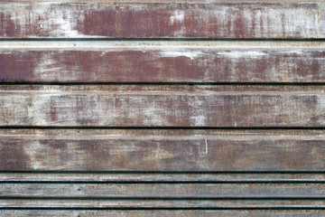 Rusty steel surface with scratches and peeling paint. Texture, background.