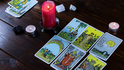 New York, USA-19.05.2020:Candlelight divination on religious holidays and Christmas. On the table are cards for divination, magic stones and lighted candles for divination and fortune telling.