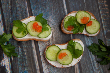 Fototapeta na wymiar Sandwiches with greens on a wooden background