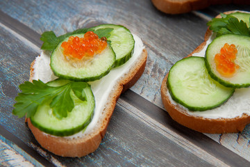 Sandwiches with greens on a wooden background