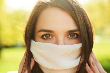 Close up portrait of young woman wearin fashion protection mask