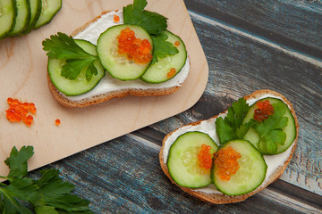 Sandwiches with greens on a wooden background