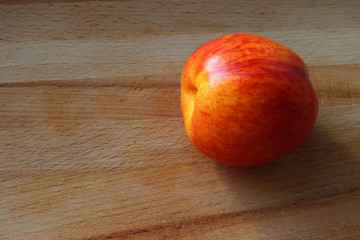 nectarine, peach on a wooden background