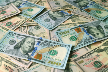 Fototapeta na wymiar Closeup heap of United States dollar bills focus for the concept of business and wealth