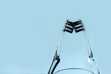 Toothbrushes and tooth powder on a blue-black background with mint leaves. Flat lay.