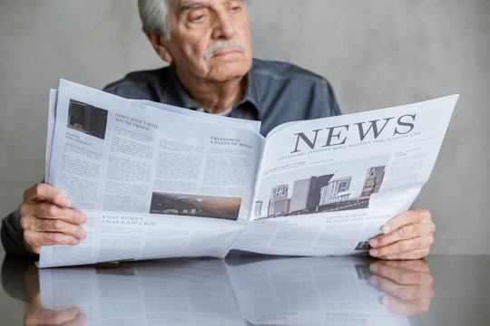 Senior man reading the news during coronavirus pandemic