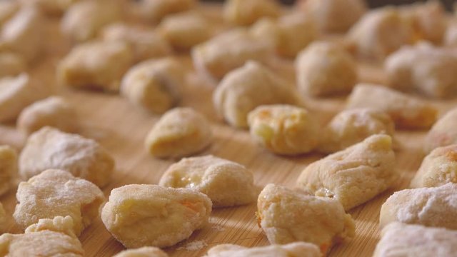 Steady Cam On Chopping Board With Handmade Potato Dumplings Ready To Cook