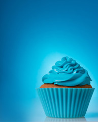 Single blue cupcake on the blue background, free space