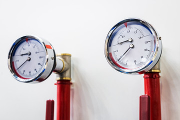high pressure gauges installed on a water or gas system. Selective focus