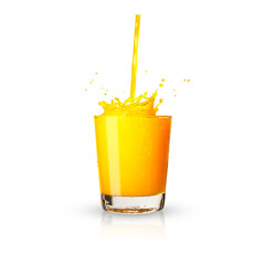 Pouring a glass of orange juice creating splash isolated on white background.