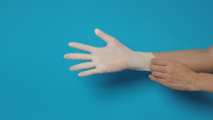 Right hand wearing white glove and left hand is pulling.Put on blue background.