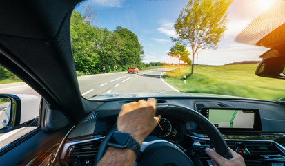 hands of car driver on steering wheel, road trip, driving on highway road