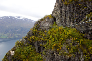 Beautiful side view on the top of via ferrata Loen Norway with suspension bridge in autumn,scandinavian nature,outdoor activity,norwegian lifestyle,print for poster,cover,calendar,