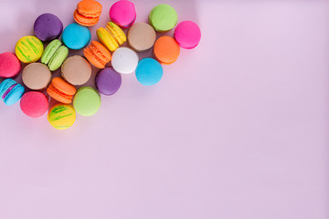 Dessert cake macaron or macaroon on pink background top view. Flat lay composition