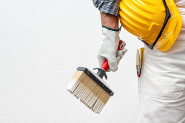 House painter worker at work in the construction site. Building.