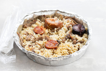 rice with duck and smoked sausages in plastic box