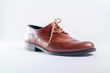 Classic brown leather one shoes on white background. Concept