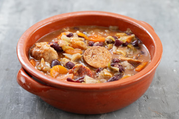 typical portuguese dish Feijoada in brown ceramic dish
