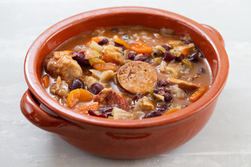 typical portuguese dish Feijoada in brown ceramic dish