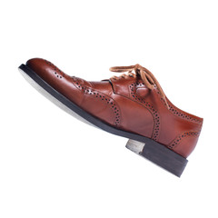 Brown leather shoes in perspective and isolated on white