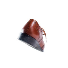Brown leather shoes in perspective and isolated on white
