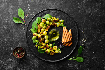 Brussels sprouts fried with sauce and toast bread. Rustic style. Top view. Free space for your text.