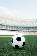 Fototapeta na wymiar soccer ball on grassy football pitch at stadium