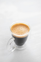 a cup of coffee on ceramic background
